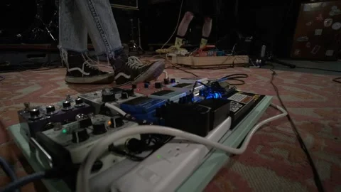 Gutar Player Adjusts Pedal Steps On Pedal Board Video stock 159818479