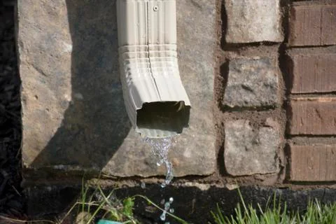 Gutter Downspout with water Stock Photos