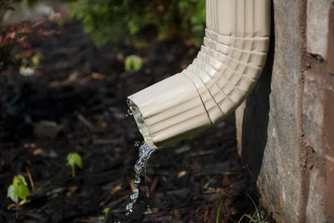 Gutter Downspout with water - side view Stock Photos