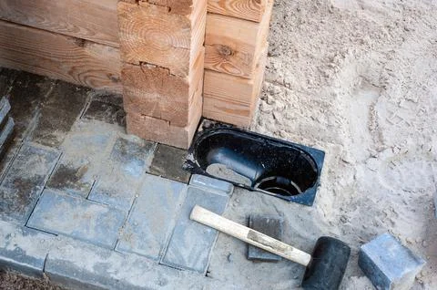 Gutter, gutter, drain for water after rain on the sidewalk. Installation of p Stock Photos