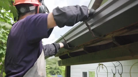 Gutter Series 09 - Worker Installing New Metal Gutter Stock Footage 343245910