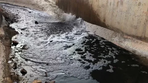 Gutter water dumps to canal Stock Footage 156470949