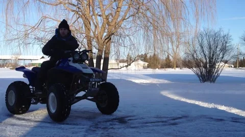 Guy on 4 wheeler doing donuts and being funny Stock Footage 46464748