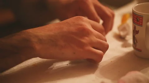 Guy accurately puts a candy wrapper from candy Stock Footage 56909887