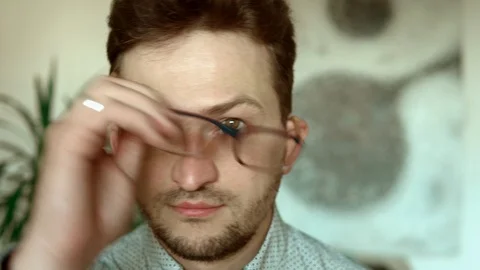 Guy administers eye drops to alleviate irritated dry eye. Water drop makes Stock Footage 91552449
