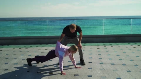 The guy aggressively teaches the girl to do the exercises correctly Stock Footage 143035526