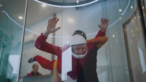 A guy in an air tube with an instructor Stock Footage 169894060