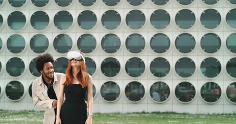 A guy and a girl experimenting virtual reality in the city center Stock Footage 201114534
