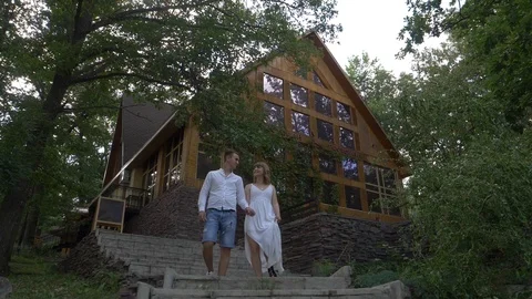 A guy and a girl go down the stairs Stock Footage 122004059