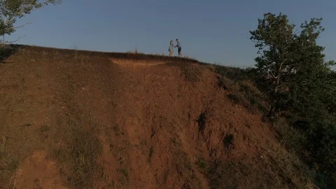 Guy and girl having fun at sunset. Aerial Stock Footage 122002045