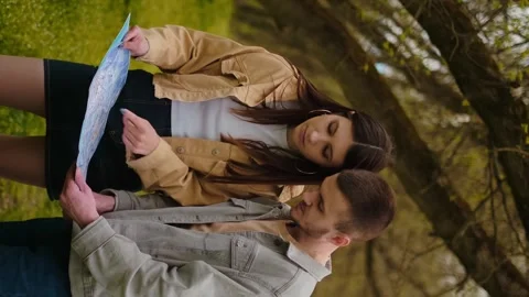 A guy and a girl with a map in hand in the forest. Navigation apps, geolocation Stock Footage 271556749