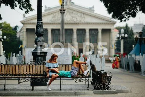 Guy and girl sitting on a bench Stock Photos