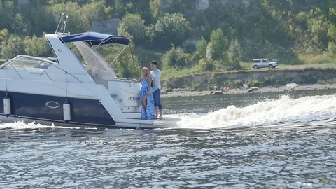 Guy and the Girl Stand Back in the Boat Stock Footage 87972115