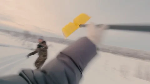 A guy and a girl throw a plastic shovel at each other in winter. Stock Footage 327144993