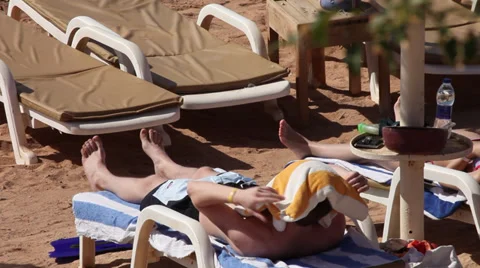 A guy and his girlfriend sunbathing at El Fanar, Sharm El Sheikh, Egypt Stock Footage 39376916