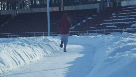 The guy and the snowy stadium Stock Footage 148670131
