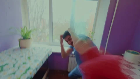 The guy angered his girlfriend and she jokingly beat him with a plastic bottle. 스톡 동영상 332285174