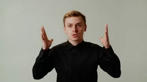 A guy is angry, covers ears and ready to explode from a surge of emotions due Stock Footage 253036219