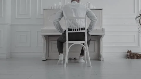 The guy approaches the piano with the cat Stock Footage 201250602