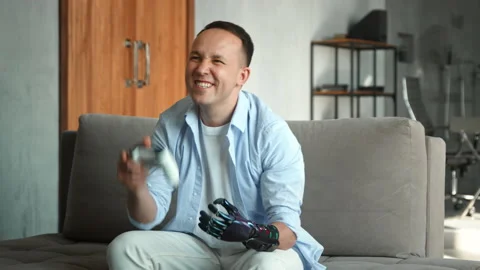 Guy with artificial bio hand prothesis wins console game Stock Footage 157534468