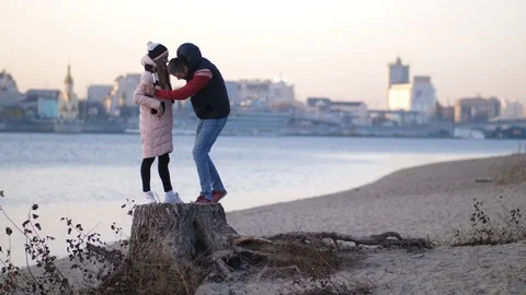 The guy asks the girl to marry him on the beach in the autumn 4K Slow Mo Stock Footage 100066169