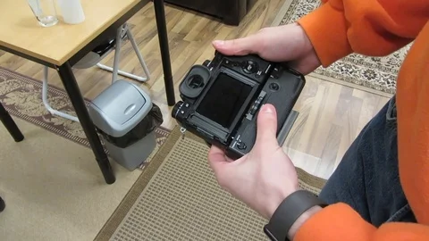 Guy attaching battery power booster grip to a camera. Stock Footage 99467258