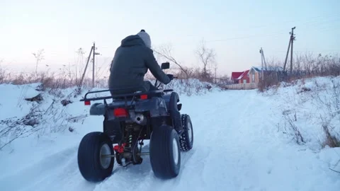 Guy on an ATV in winter stuck in a snow 動画素材 147851876