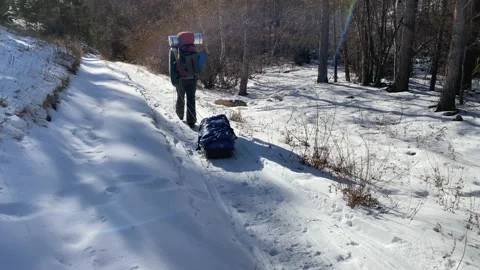 A guy with a backpack goes on a winter hike Video stock 151065811