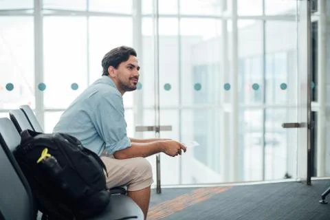 The guy with the backpack is sitting at the airport. Foto stock