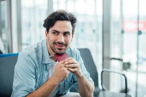 The guy with the backpack is sitting at the airport. Stock Photos
