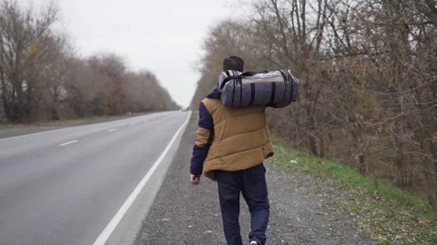 Guy with bag is walking along the track with bag Stock Footage 169510008