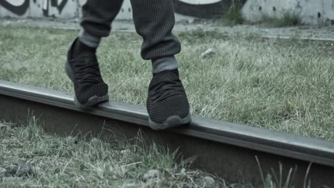 The guy is balancing on the tram tracks Stock Footage 162037669