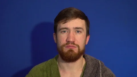 The guy in the Bathrobe after a shower, combing beard Stock Footage 124462291