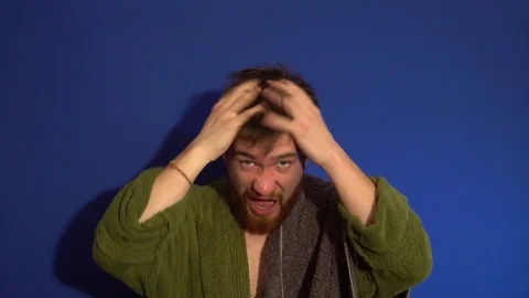 The guy in the Bathrobe after a shower, scratching his head Stock Footage 124303191