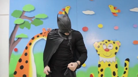 The guy in the Batman costume dancing on the Playground Stock Footage 111200539