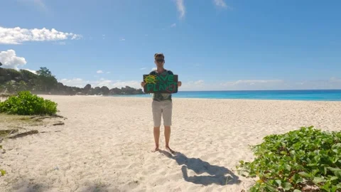 The guy on the beach against the background of the ocean Stock Footage 155797790