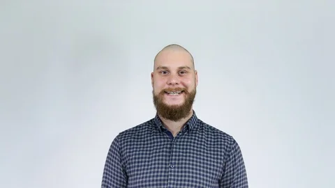 The guy with the beard aggressive considering his bald head in the reflection. Stock Footage 122012471
