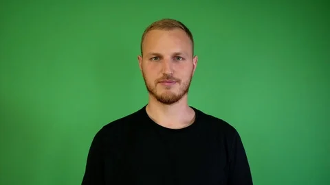 Guy with a beard smiles on a chroma key Video stock 115237154