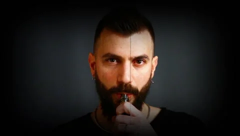 Guy with a beard smoking electronic cigarette 動画素材 132998486