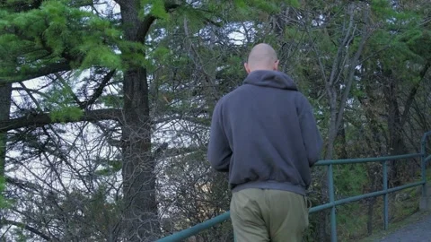 A guy with a beard walks along the path among the trees Stock Footage 219967981
