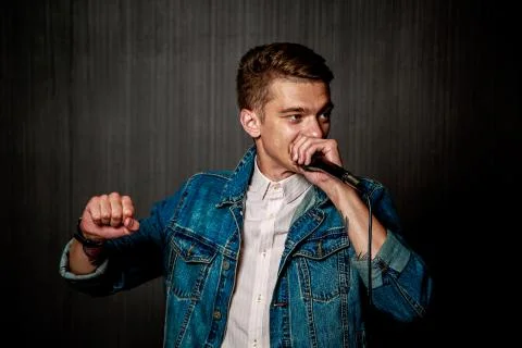 Guy Beat Boxing with Microphone. Dark Background. Stock Photos