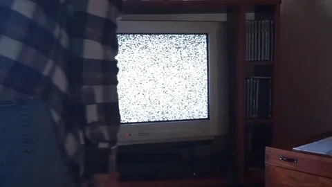 Guy beat up the remote control of his CTR TV Stock Footage 100321315