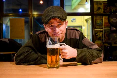 Guy with beer in the bar Stock Photos