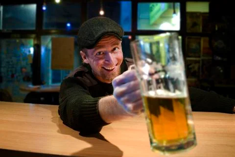 Guy with beer in the bar 스톡 사진