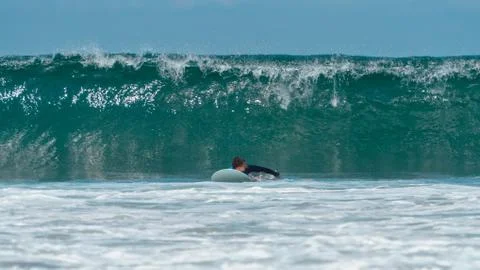 The guy is a beginner surf covers big wave Stock Illustration