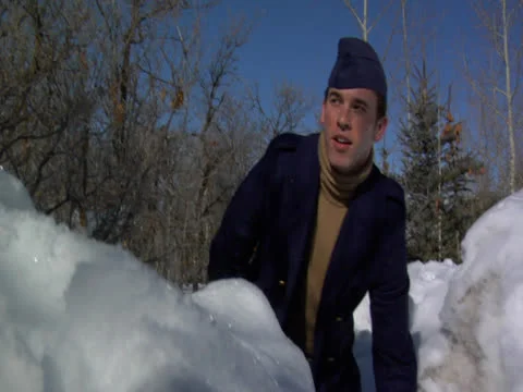 A guy behind the snow mound fights with someone by throwing ice Stock Footage 23117764