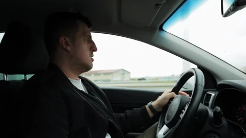 The guy behind the wheel drives the car carefully and with concentration. 스톡 동영상 220227024