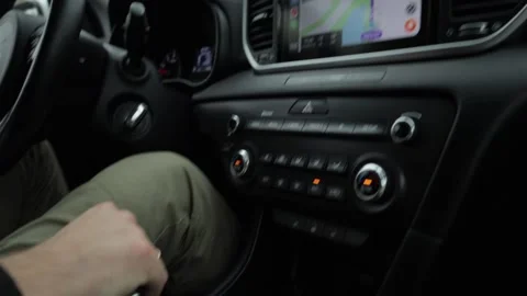 The guy behind the wheel uses navigation in the car. Hand enters destination  스톡 동영상 220227002