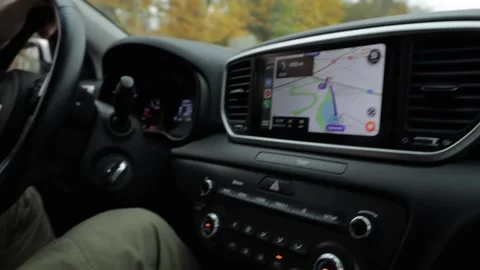 The guy behind the wheel uses navigation in the car. Hand enters destination  Stock Footage 220227025