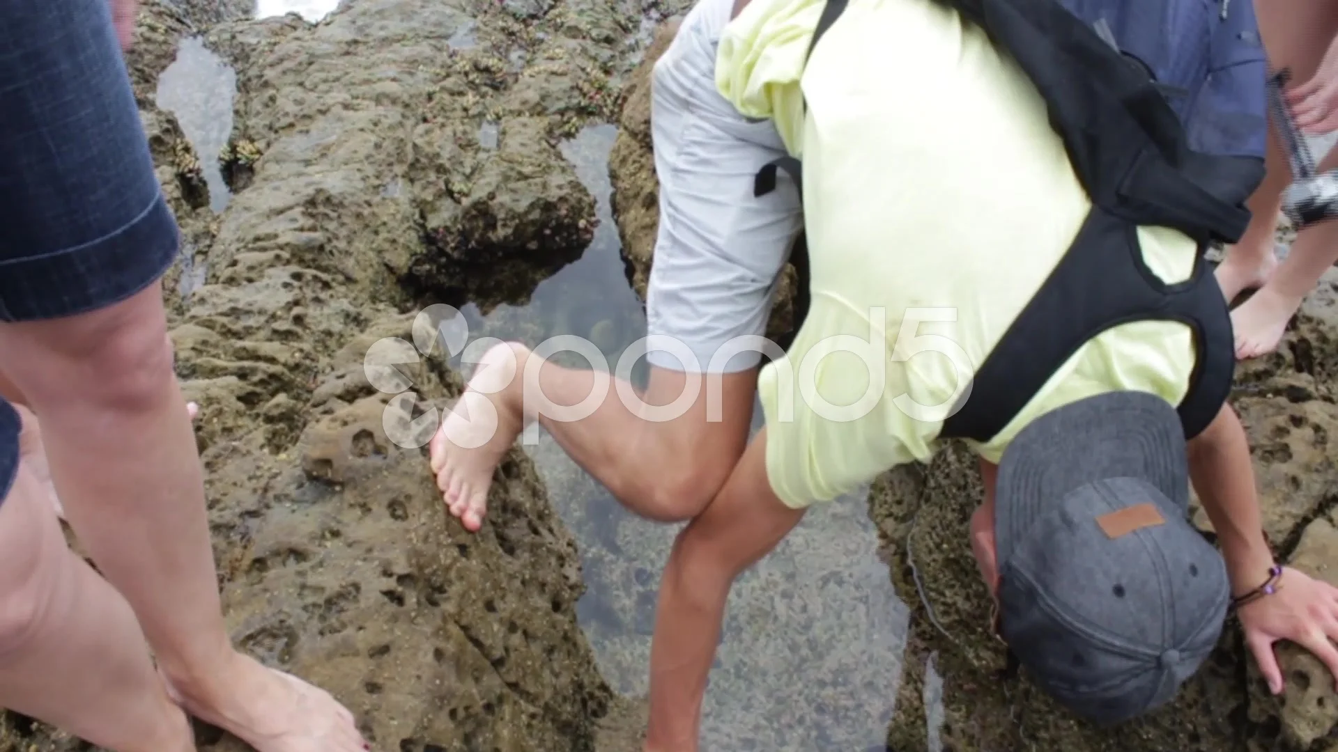 Guy Bending Over Rock Hole with Water